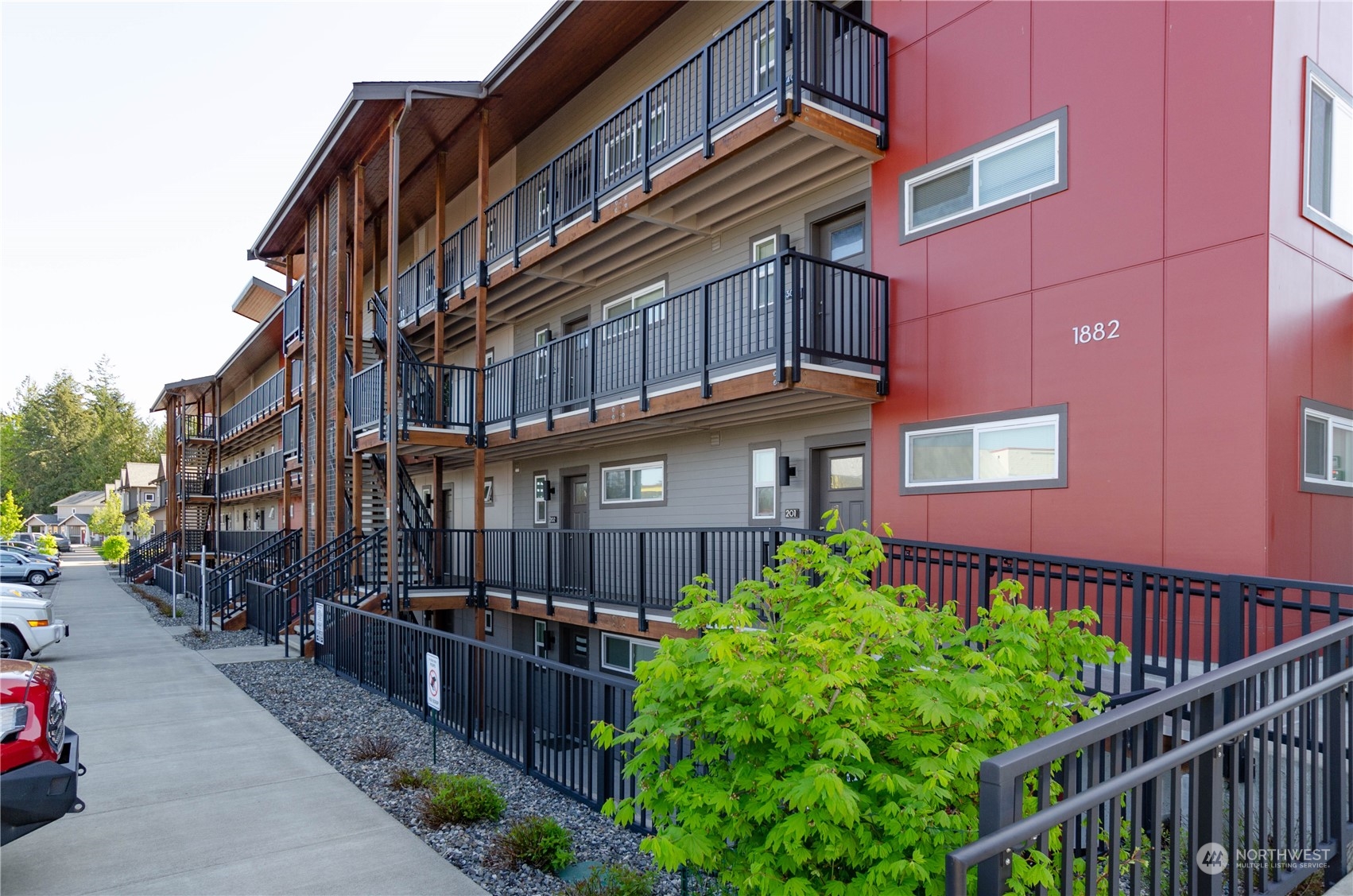 1882 Front Street, Unit 208 Lynden, WA 98264 - Photo 10 of 30 a front view of a building with balcony and trees