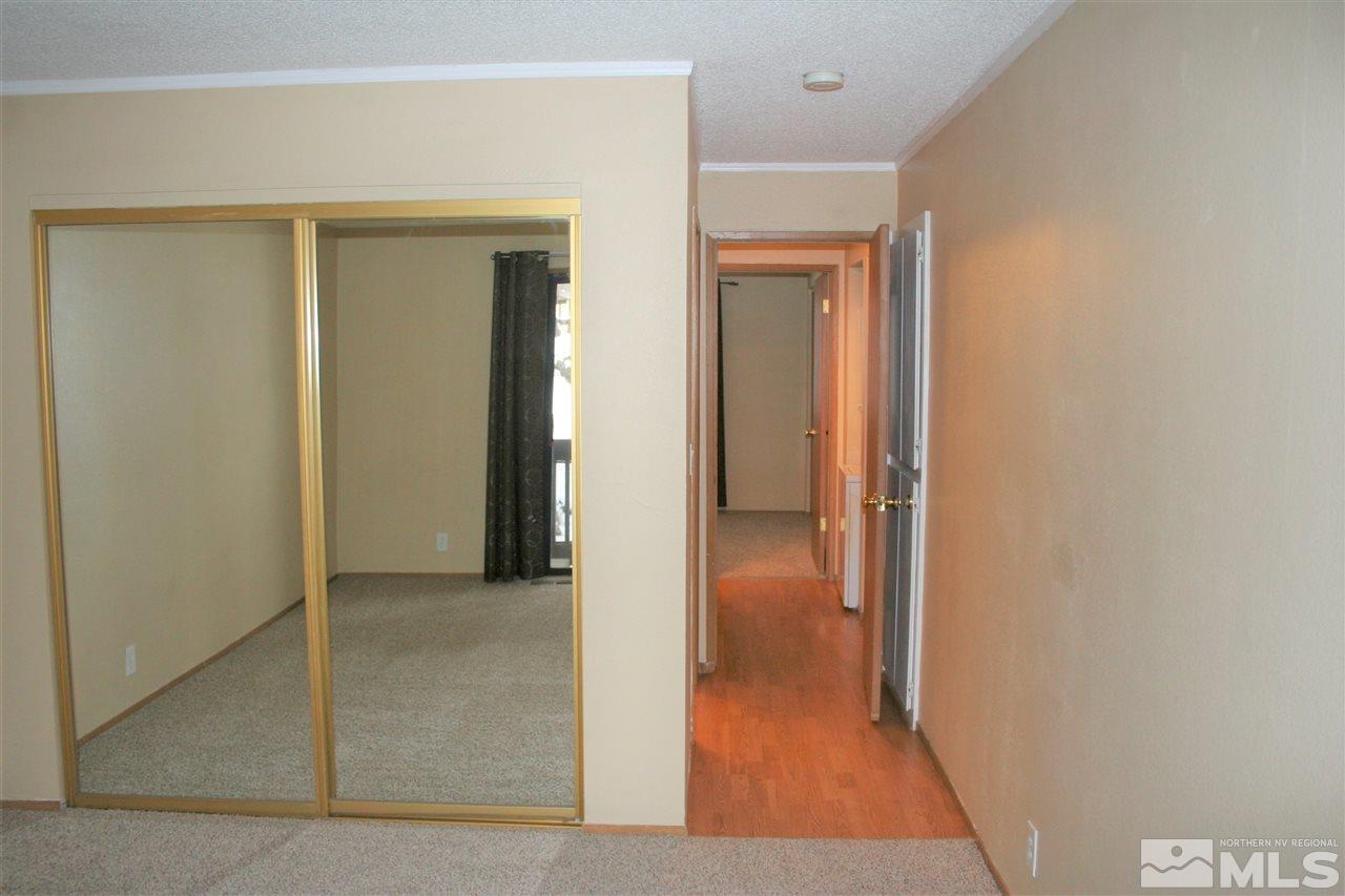 2989 Tierra Verde East Reno, NV 89512 - Photo 11 of 18 a view of a hallway with wooden floor