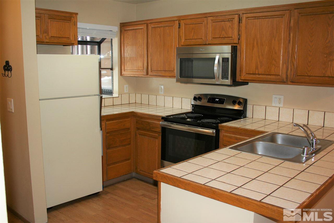 2989 Tierra Verde East Reno, NV 89512 - Photo 4 of 18 a kitchen with a refrigerator and a sink