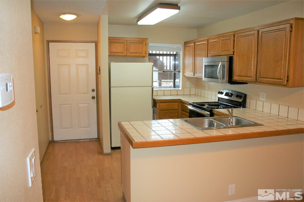 2989 Tierra Verde East Reno, NV 89512 - Photo 5 of 18 a kitchen that has a sink and a refrigerator