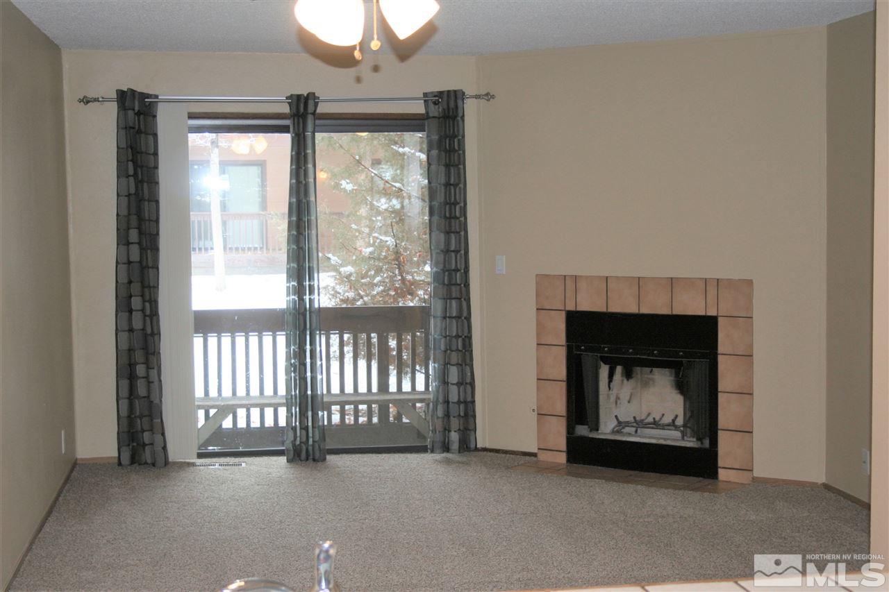 2989 Tierra Verde East Reno, NV 89512 - Photo 7 of 18 a view of an empty room with a fireplace and a window
