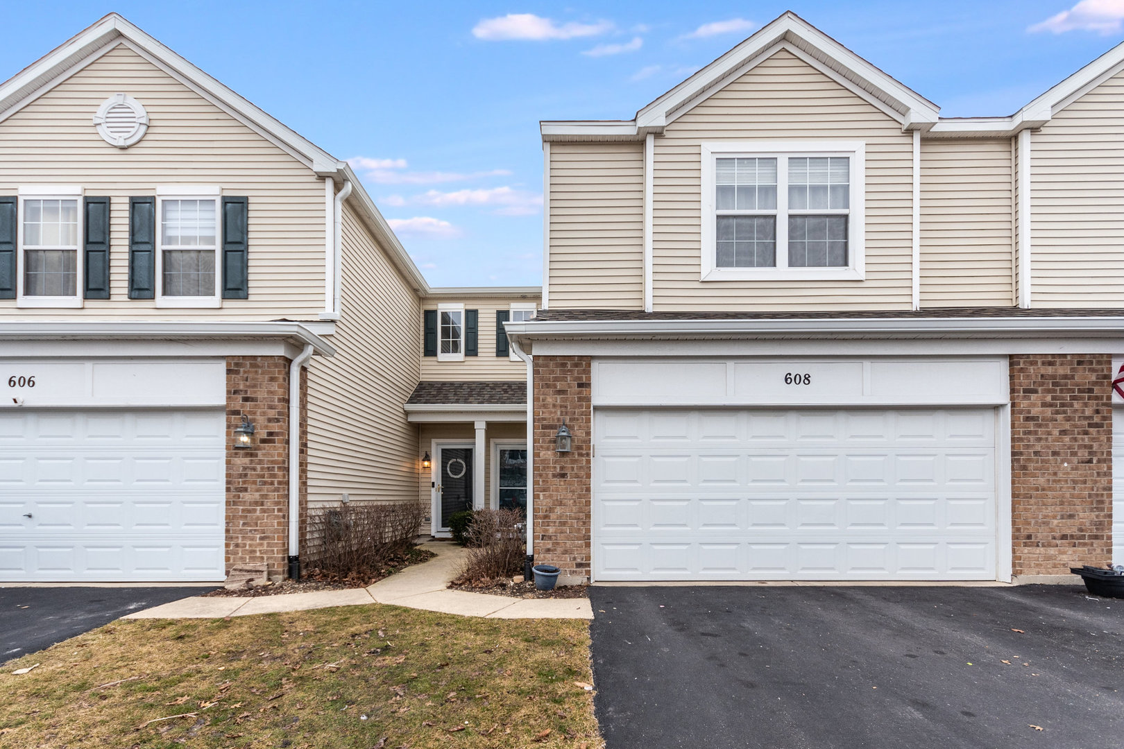 608 Springbrook Trail North Oswego, IL 60543 - Photo 1 of 24 a front view of a house with a yard and garage