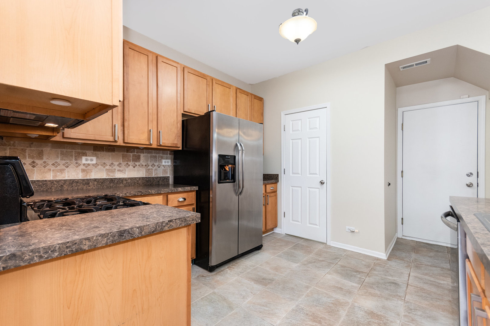 608 Springbrook Trail North Oswego, IL 60543 - Photo 11 of 24 a kitchen with stainless steel appliances granite countertop a refrigerator and a stove