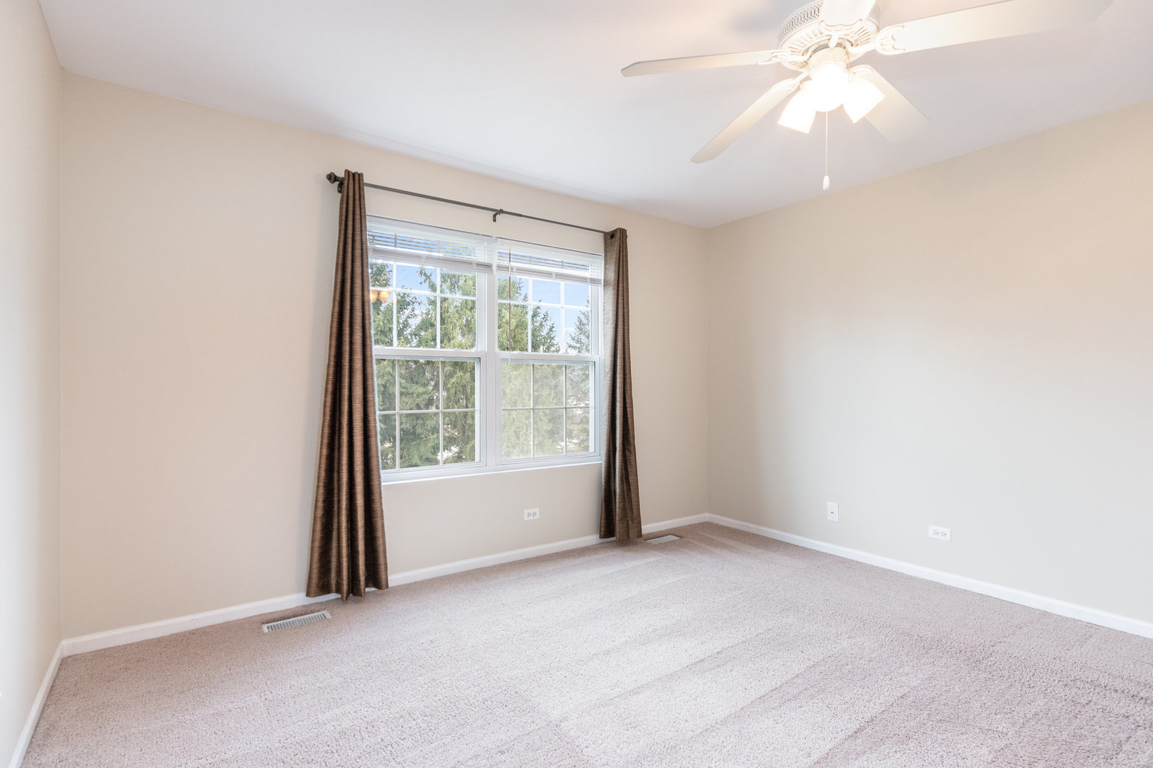 608 Springbrook Trail North Oswego, IL 60543 - Photo 14 of 24 an empty room with windows and fan