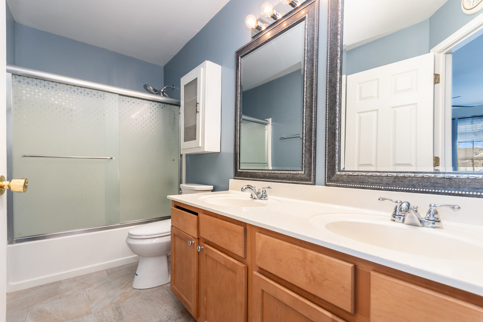 608 Springbrook Trail North Oswego, IL 60543 - Photo 17 of 24 a bathroom with a sink and a mirror