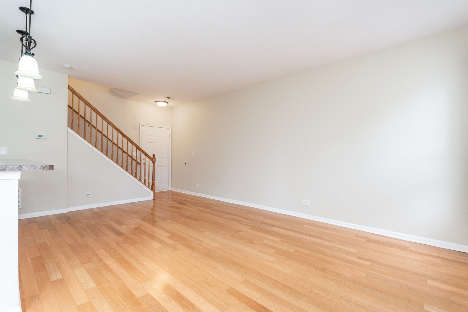 608 Springbrook Trail North Oswego, IL 60543 - Photo 4 of 24 a view of an empty room with wooden floor