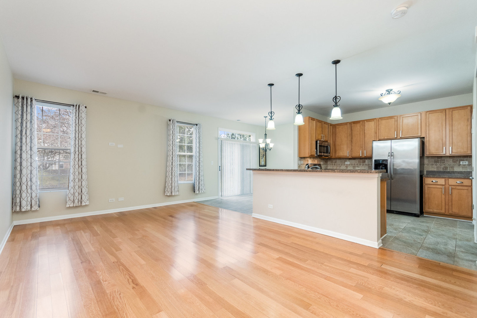 608 Springbrook Trail North Oswego, IL 60543 - Photo 5 of 24 a view of a kitchen with refrigerator microwave and wooden floor