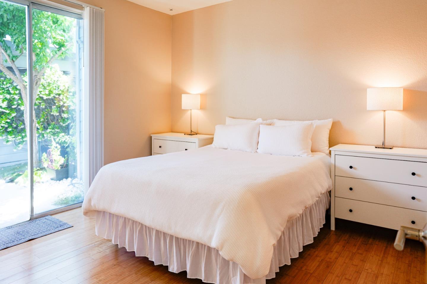 413 Cork Harbour Circle, Unit E Redwood City, CA 94065 - Photo 12 of 23 a bedroom with a bed and large window