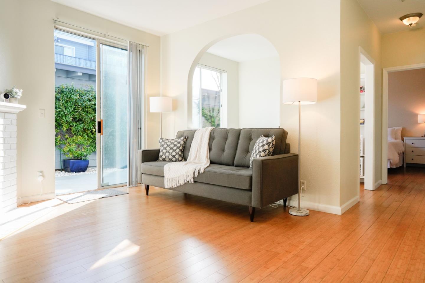 413 Cork Harbour Circle, Unit E Redwood City, CA 94065 - Photo 5 of 23 a living room with furniture and a large window