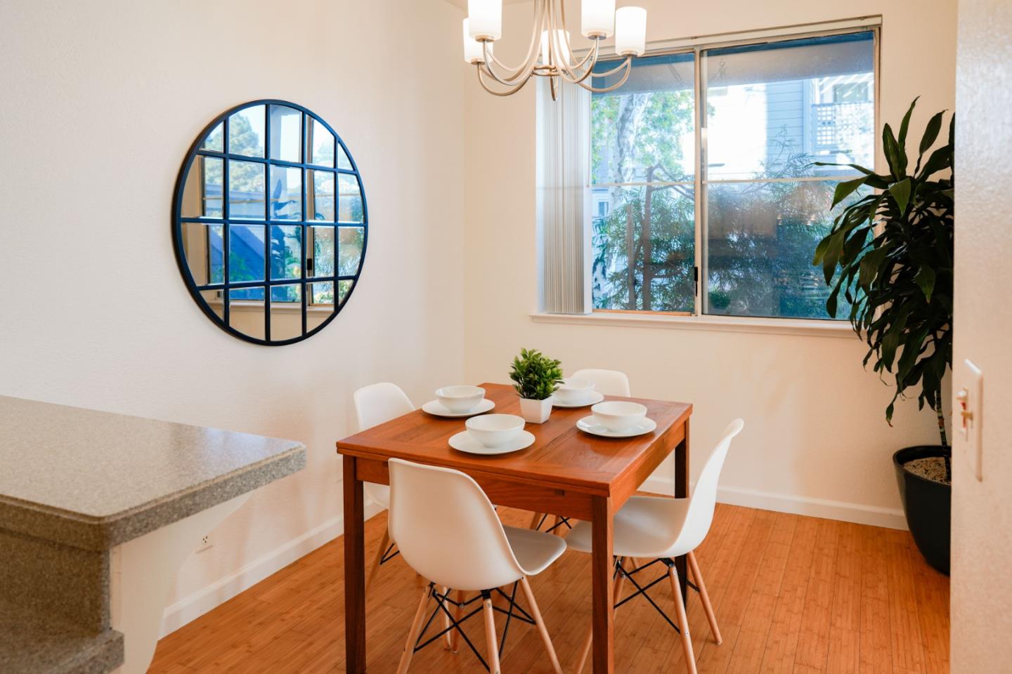 413 Cork Harbour Circle, Unit E Redwood City, CA 94065 - Photo 9 of 23 a dining room with furniture and a potted plant