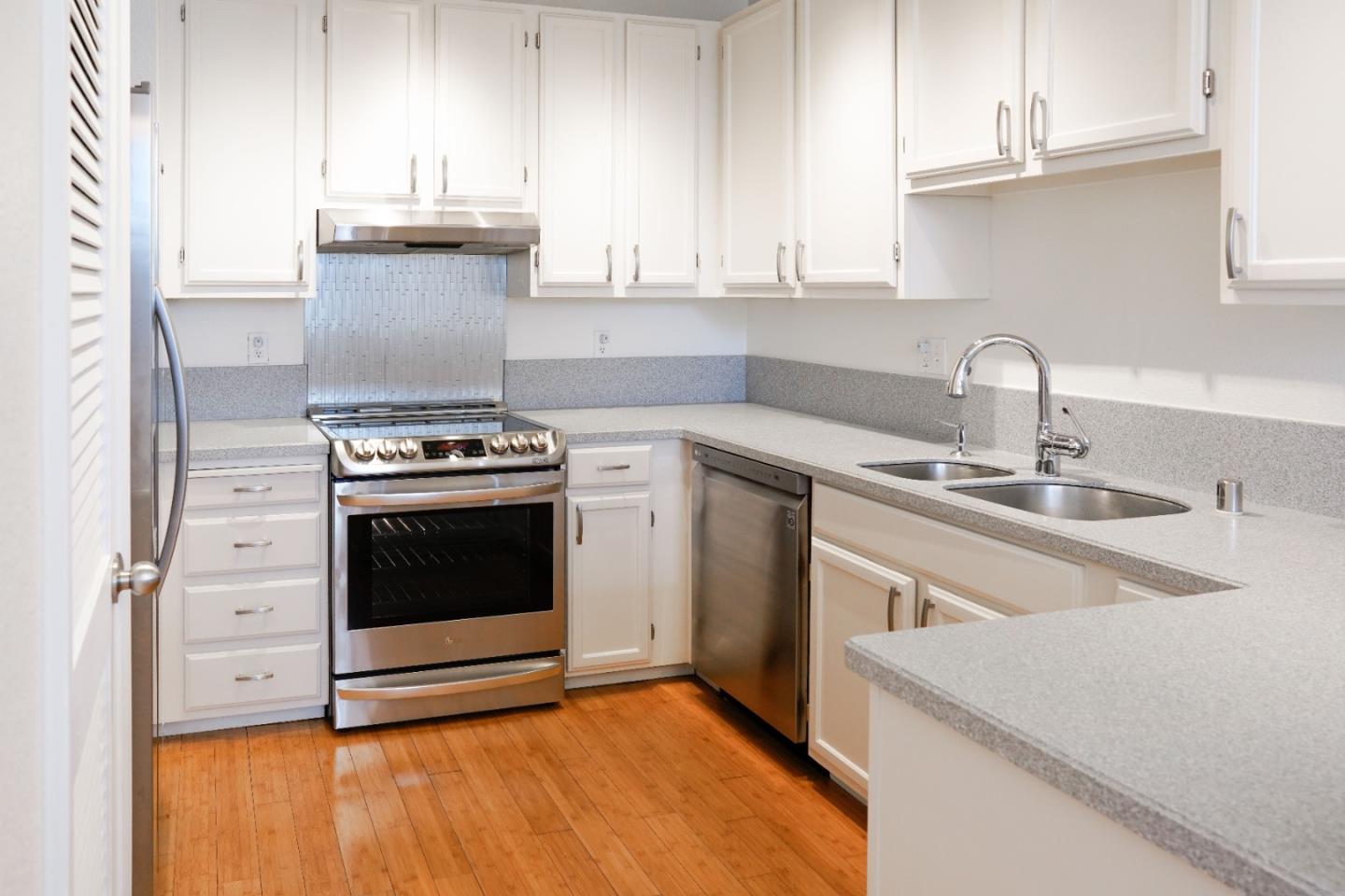 413 Cork Harbour Circle, Unit E Redwood City, CA 94065 - Photo 10 of 23 a kitchen with a stove and a sink