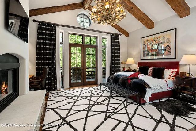 a bedroom with a bed and a fireplace