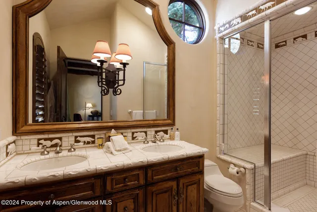 a spacious bedroom with a bed and wooden floor