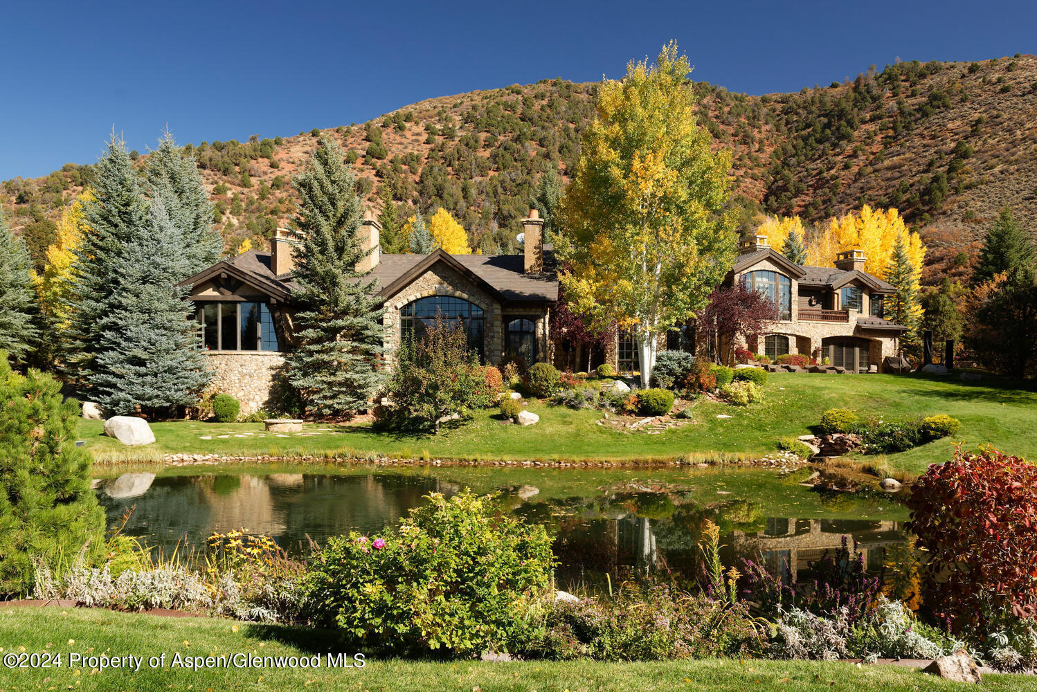 120 Running Mare Road Woody Creek, CO 81656 - Photo 47 of 53 a front view of a house with a garden