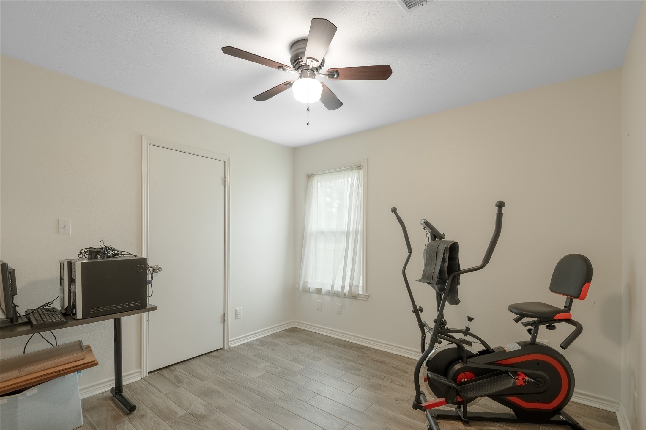758 Wire Road Huntsville, TX 77320 - Photo 12 of 44 a view of a workspace with furniture and gym equipment