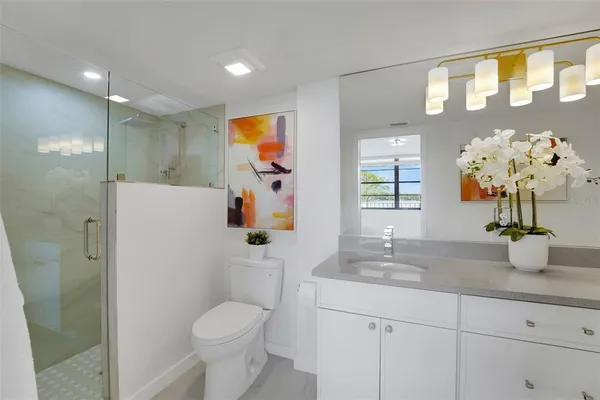 a bathroom with a sink toilet and shower
