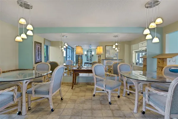 a view of a dining room with furniture and chandelier