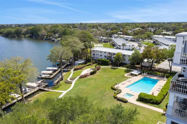 an aerial view of a house with a swimming pool outdoor seating and yard