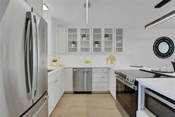 a kitchen with a stove oven and a window