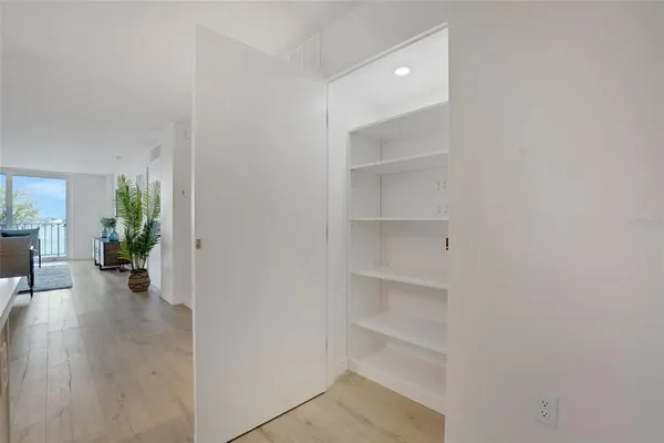 a room with a bench and a potted plant