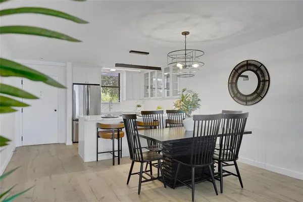 a view of a dining room with furniture and a chandelier