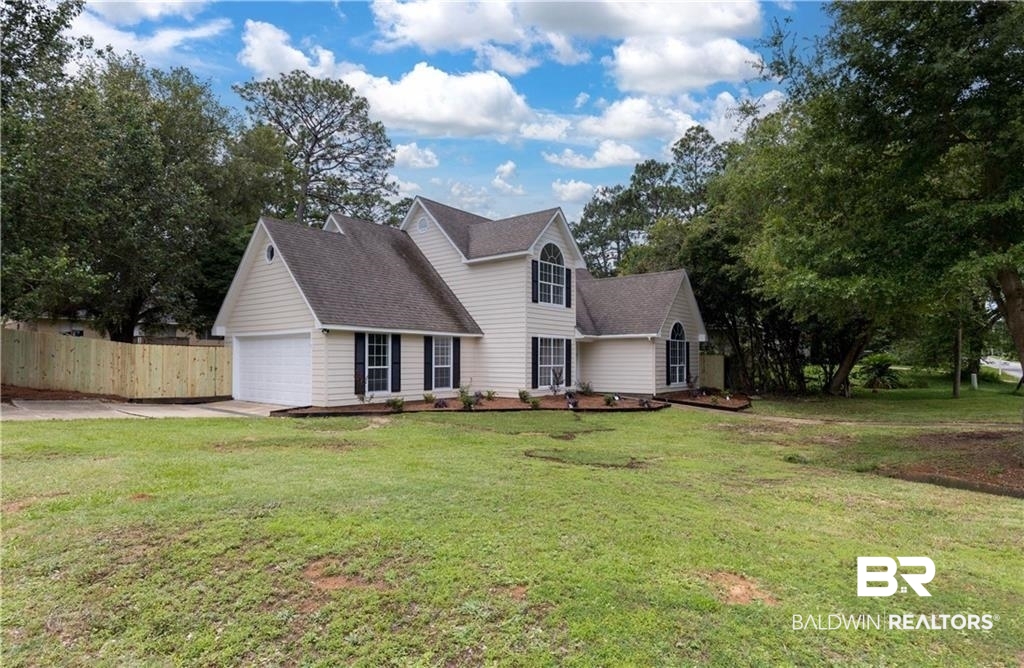 101 Lawson Road Daphne, AL 36526 - Photo 20 of 20 Two-story residence featuring light-colored siding, a dark shingle roof, and a prominent arched window on the upper level