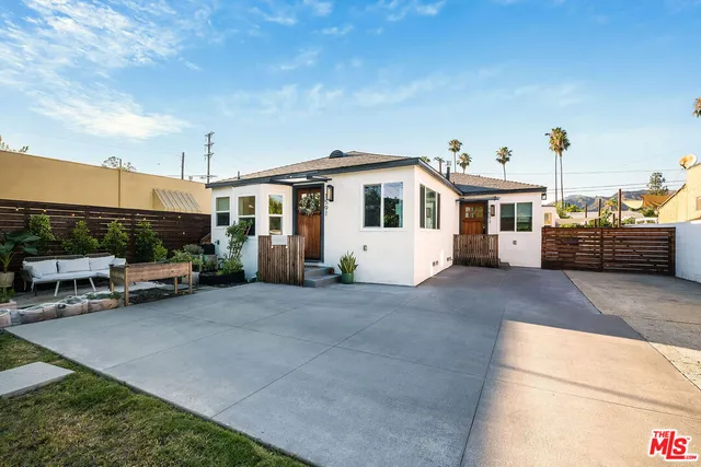 a view of a white house with a patio