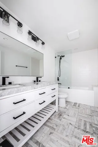 a bathroom with a tub sink and mirror