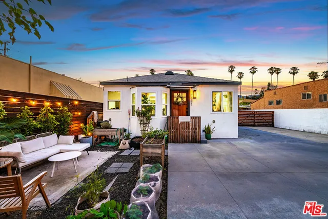 a view of a patio with plants and chairs