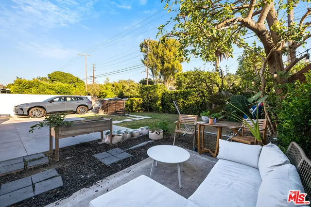 a view of a backyard with sitting area