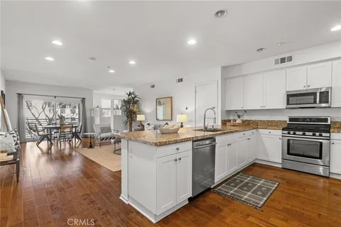 a kitchen with sink stove and cabinets