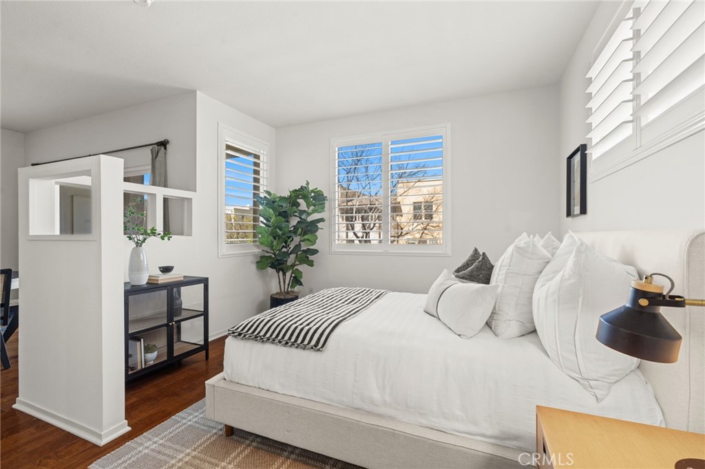 5540 Strand, Unit 201 Hawthorne, CA 90250 - Photo 15 of 31 a bedroom with a balcony a bed and a chair