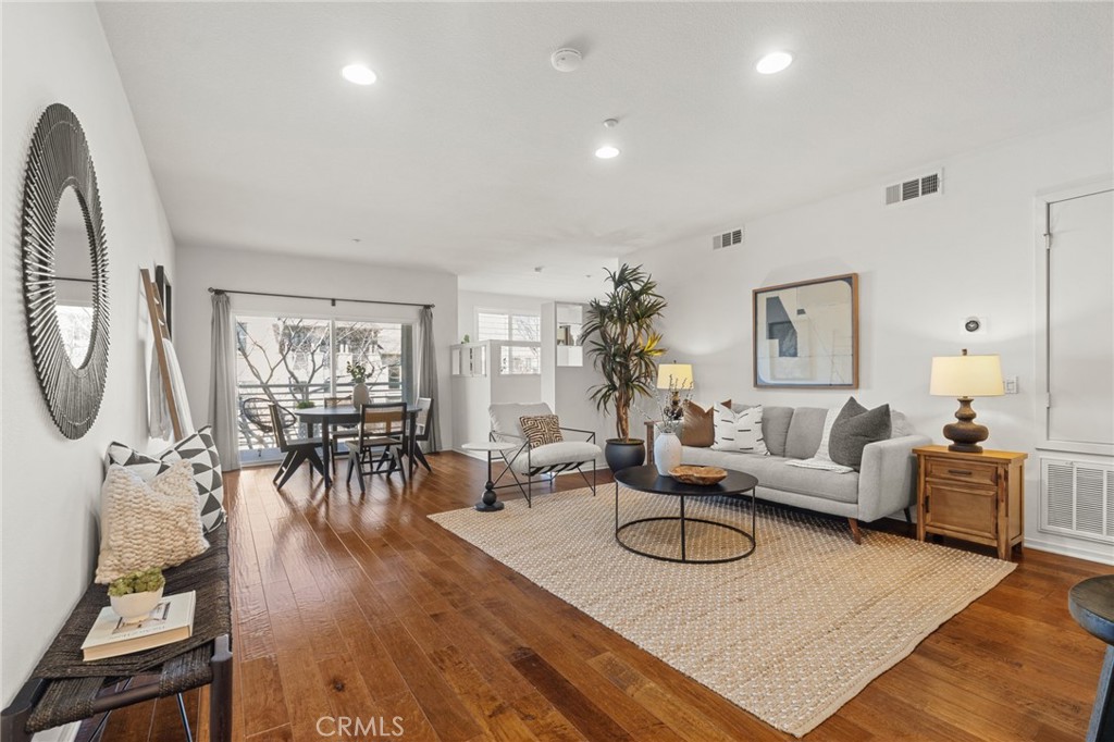 5540 Strand, Unit 201 Hawthorne, CA 90250 - Photo 2 of 31 a living room with furniture a rug a fireplace and a large window