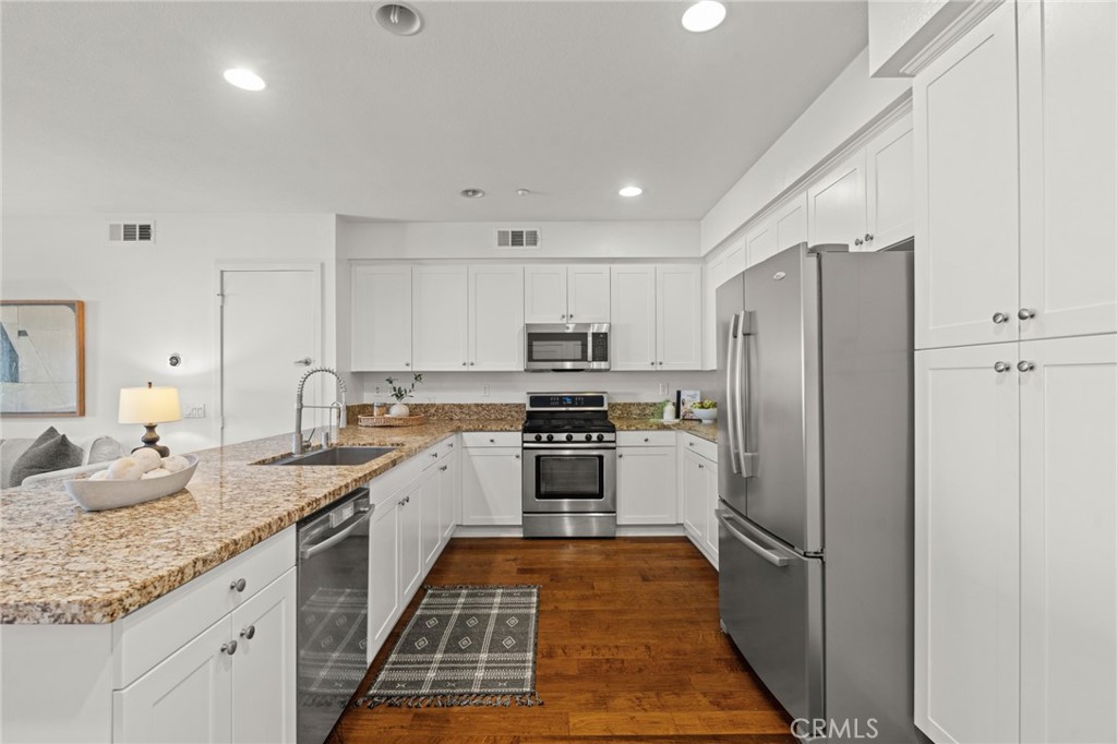 5540 Strand, Unit 201 Hawthorne, CA 90250 - Photo 7 of 31 a kitchen with granite countertop stainless steel appliances a sink and counter space