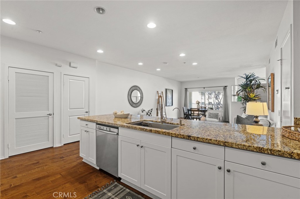 5540 Strand, Unit 201 Hawthorne, CA 90250 - Photo 8 of 31 a kitchen with granite countertop a sink and a white wooden cabinets