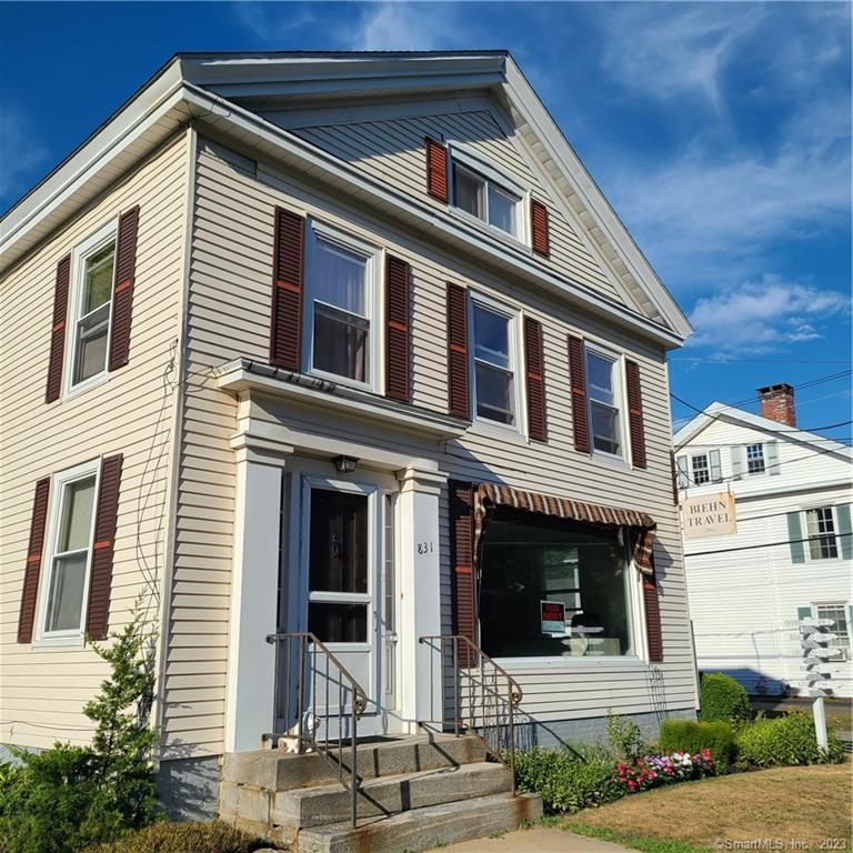 831 Boston Post Road Madison, CT 06443 - Photo 1 of 1 a front view of a house with garage
