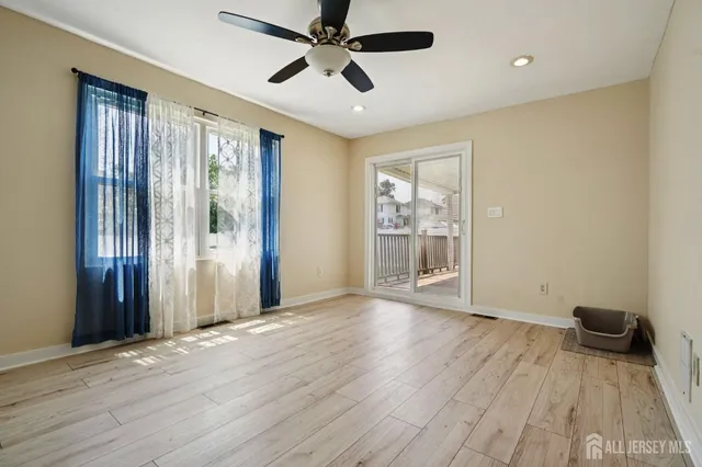 a view of livingroom with hardwood floor and a ceiling fan