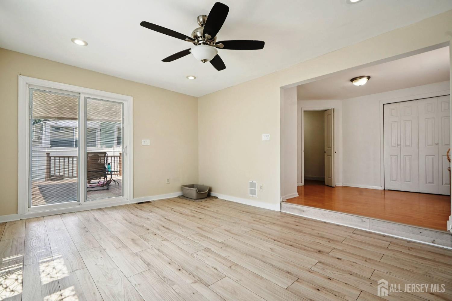 27 George Street Avenel, NJ 07001 - Photo 14 of 29 a view of an empty room with wooden floor and a window