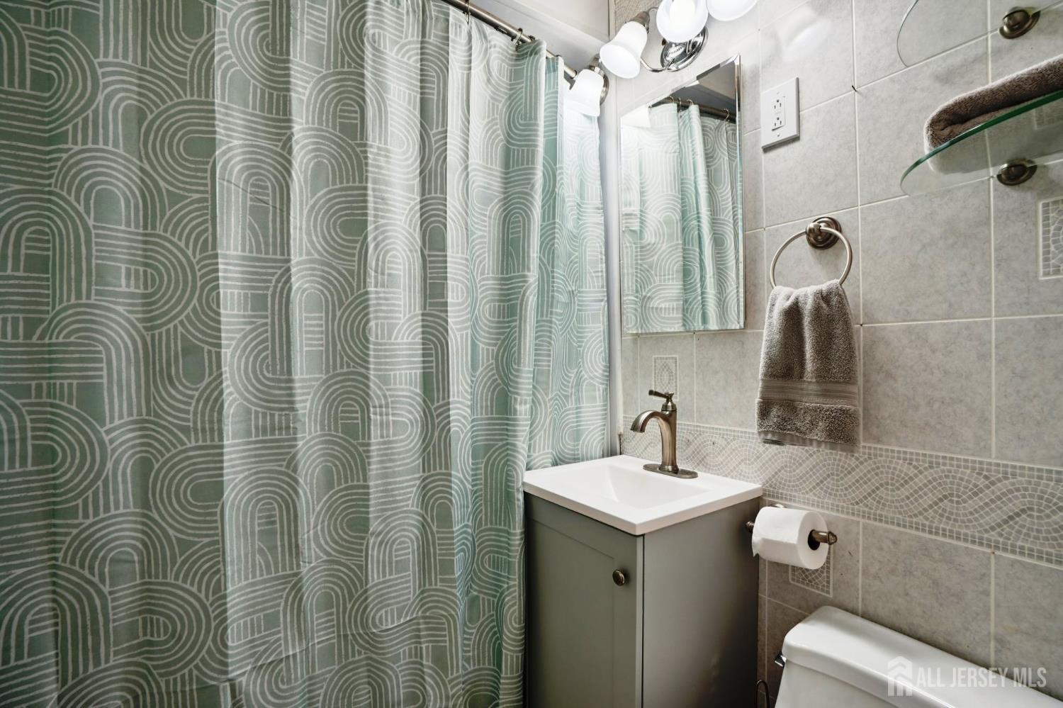 27 George Street Avenel, NJ 07001 - Photo 16 of 29 a bathroom with a sink toilet and shower