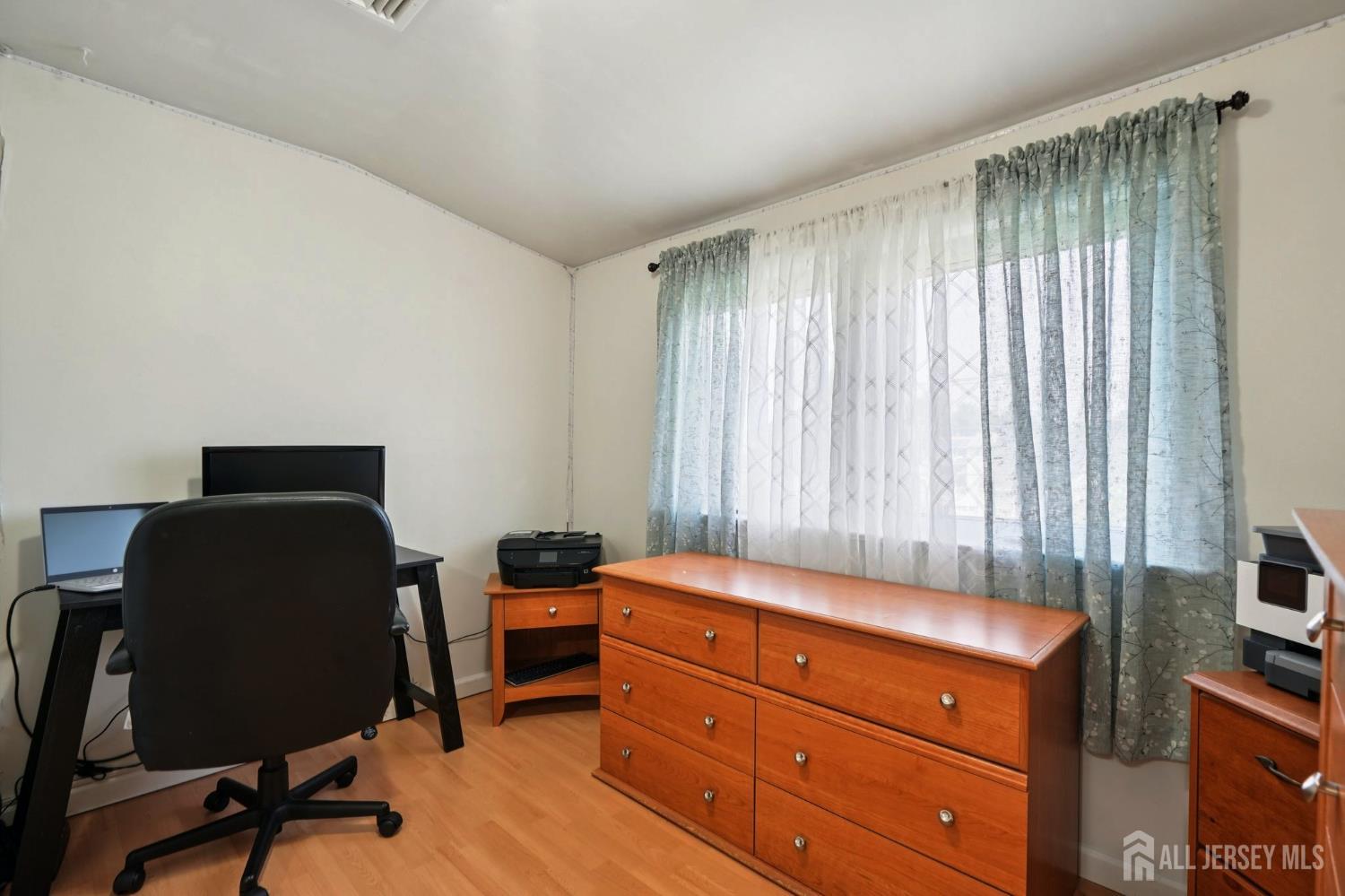 27 George Street Avenel, NJ 07001 - Photo 19 of 29 a room with a chair and a window