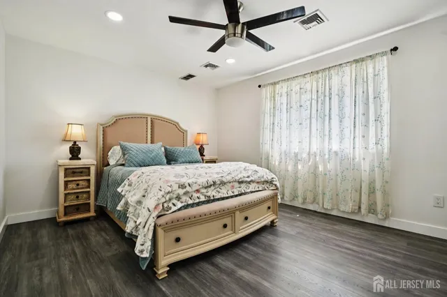 a bedroom with a bed closet and wooden floor