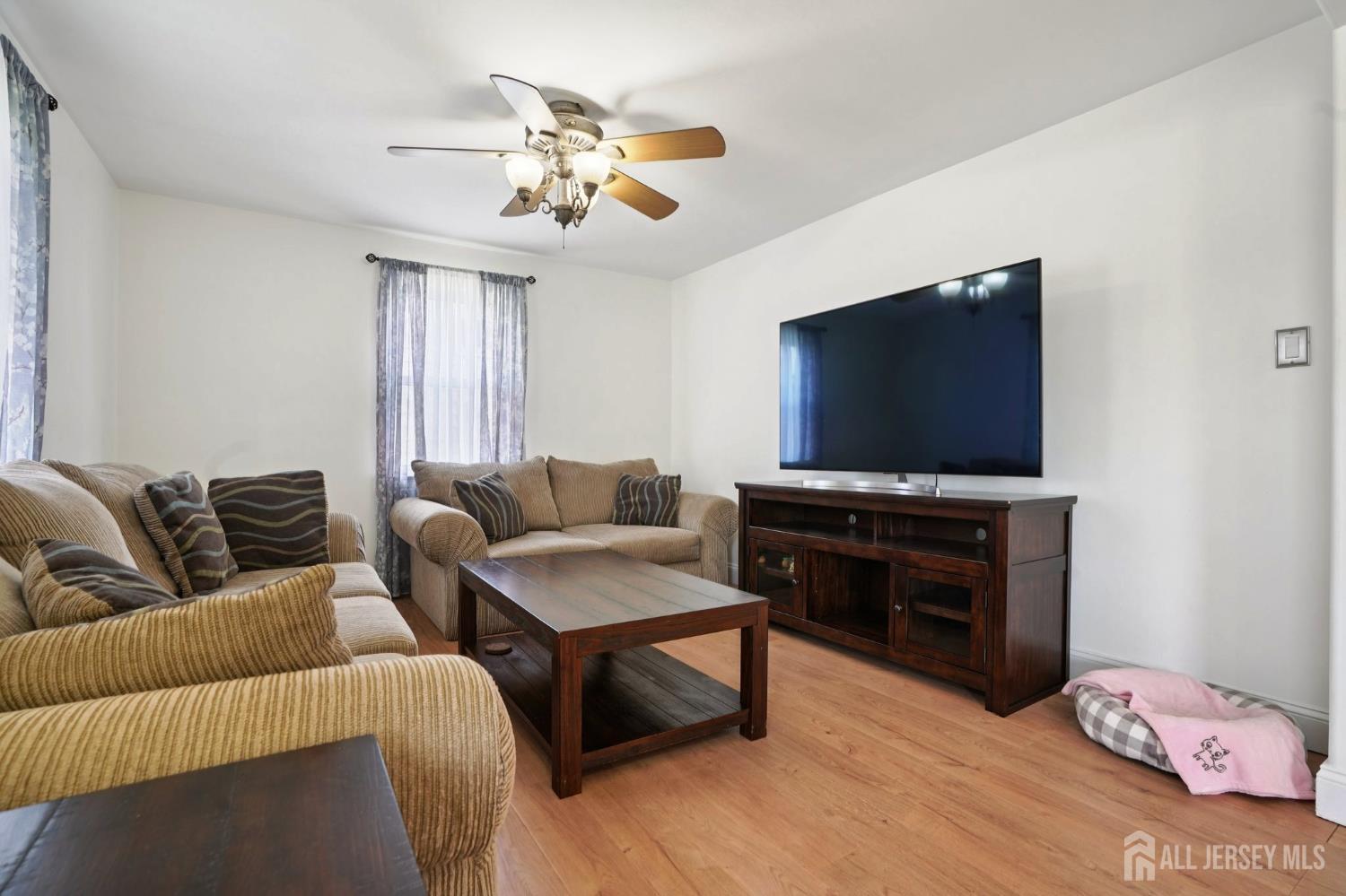 27 George Street Avenel, NJ 07001 - Photo 2 of 29 a living room with furniture and a flat screen tv