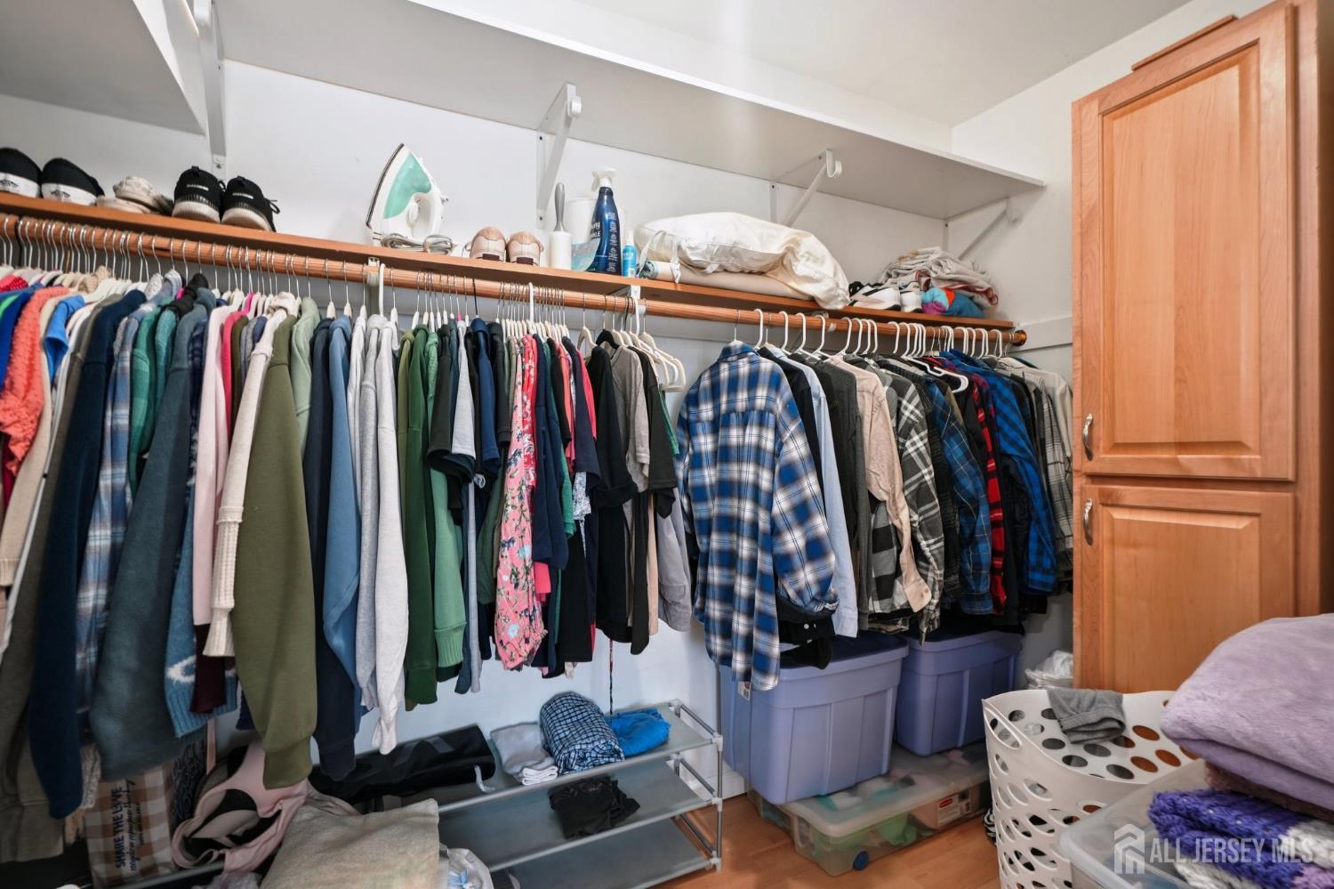 27 George Street Avenel, NJ 07001 - Photo 23 of 29 a view of walk in closet with clothes and shoes
