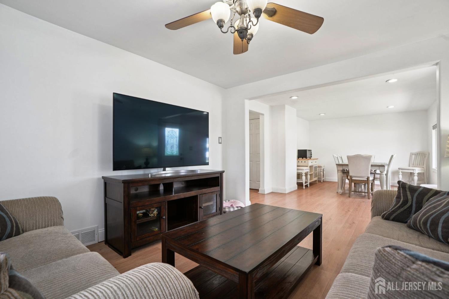 27 George Street Avenel, NJ 07001 - Photo 3 of 29 a living room with furniture and a flat screen tv
