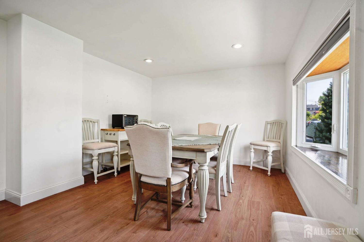 27 George Street Avenel, NJ 07001 - Photo 4 of 29 a view of a dining room with furniture window and wooden floor