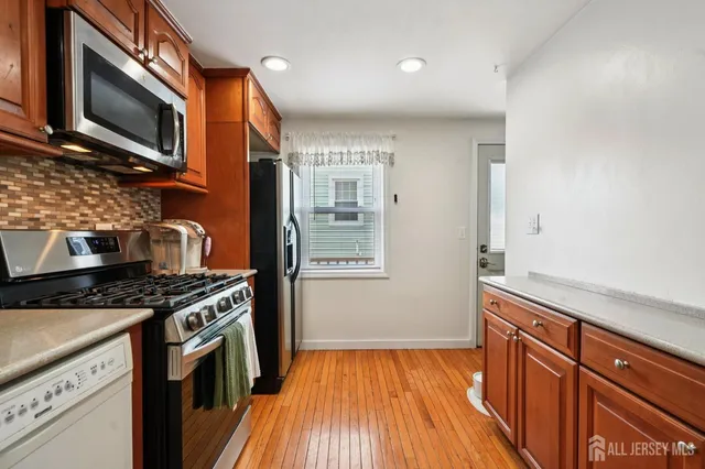 a kitchen with stainless steel appliances granite countertop a stove and a sink