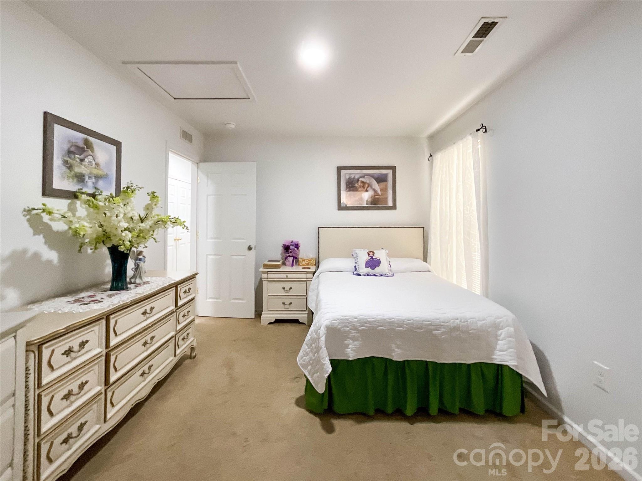 1812 Icemorlee Street Monroe, NC 28110 - Photo 13 of 18 a bedroom with a bed table and window