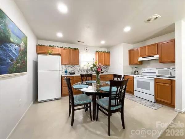 a kitchen with a refrigerator a counter top space and a center island