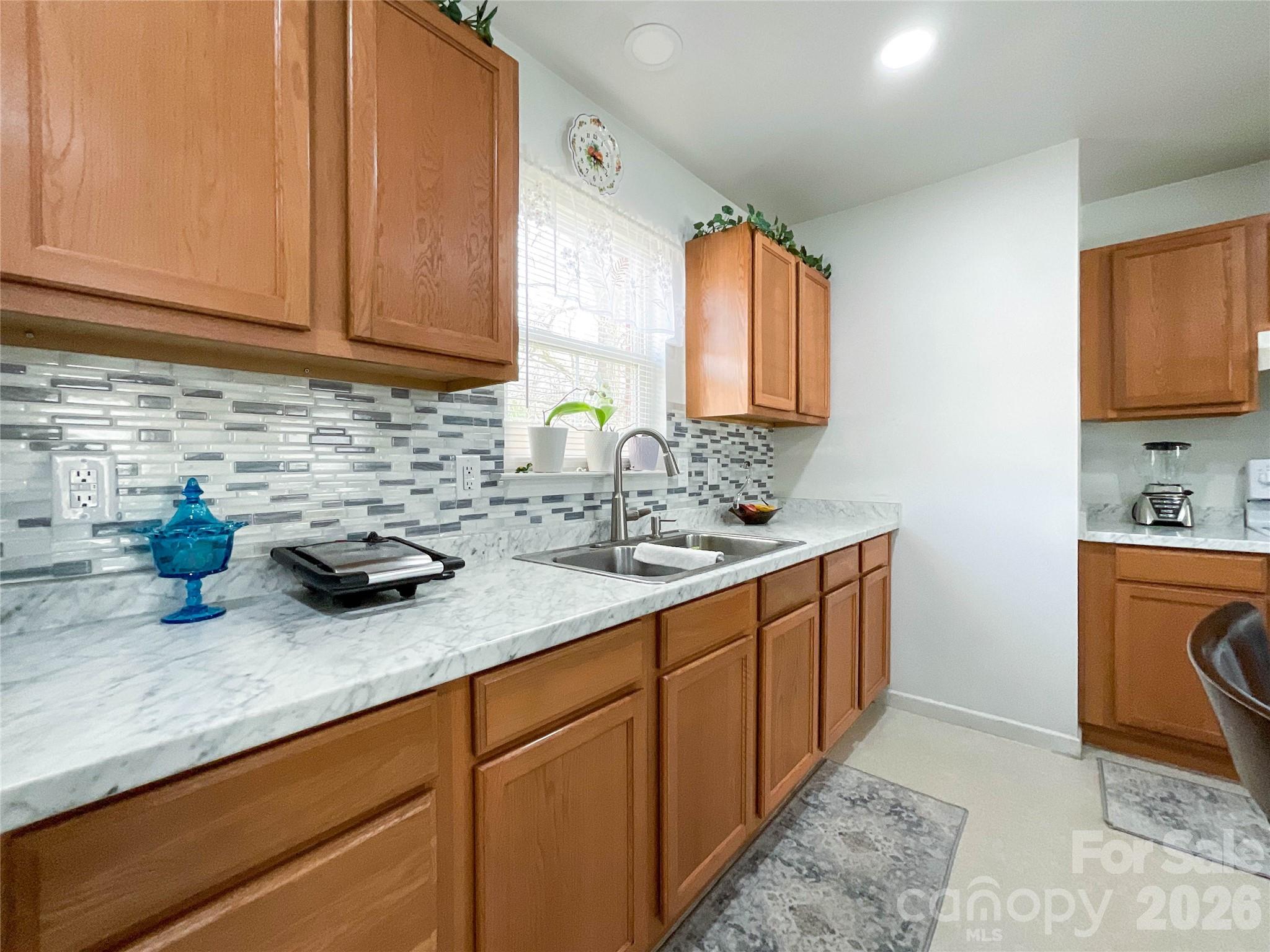 1812 Icemorlee Street Monroe, NC 28110 - Photo 8 of 18 a kitchen with sink cabinets and window