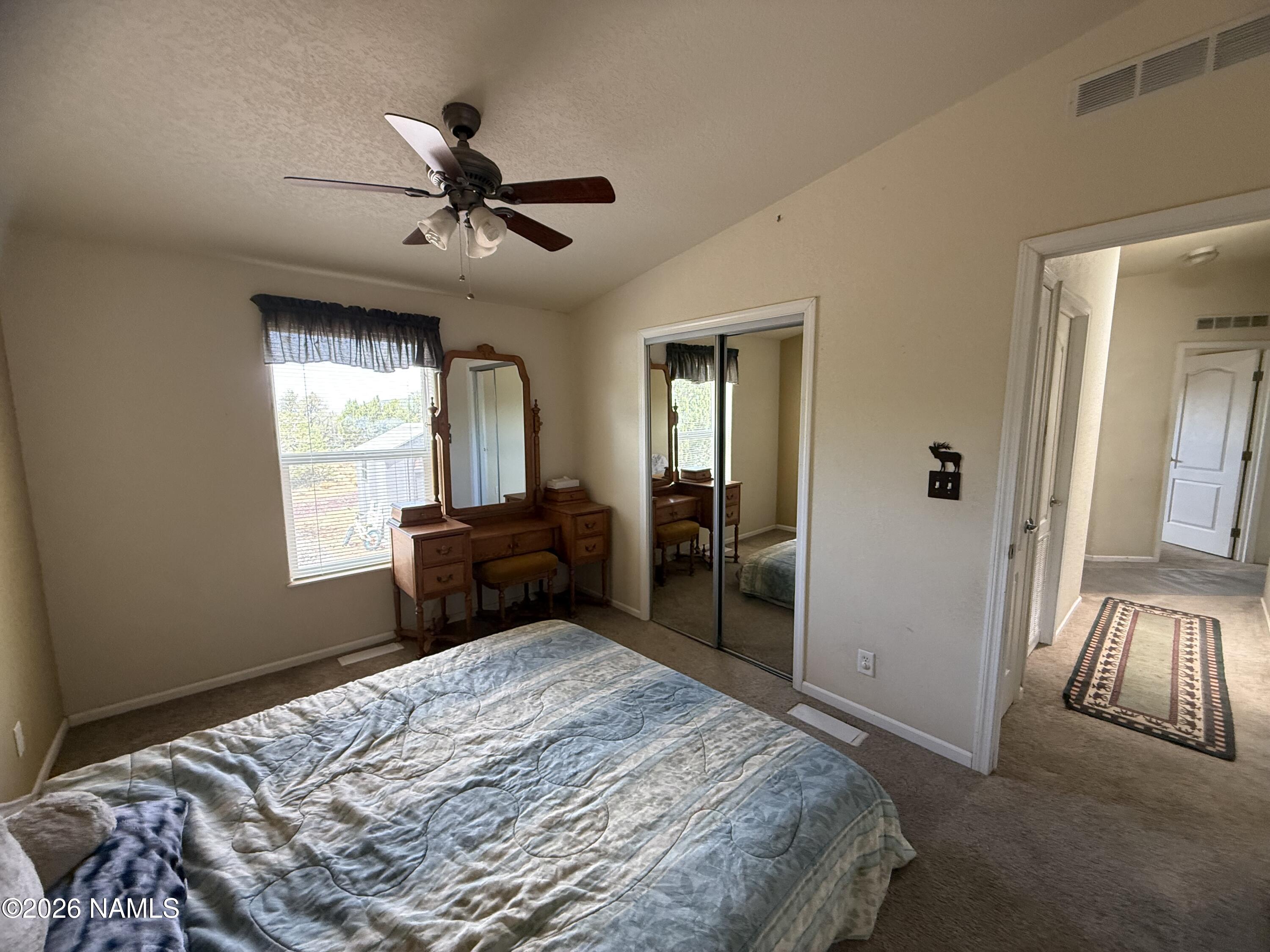 1431 East Cedar Road Williams, AZ 86046 - Photo 28 of 51 a bedroom with a bed and a large mirror with a dresser
